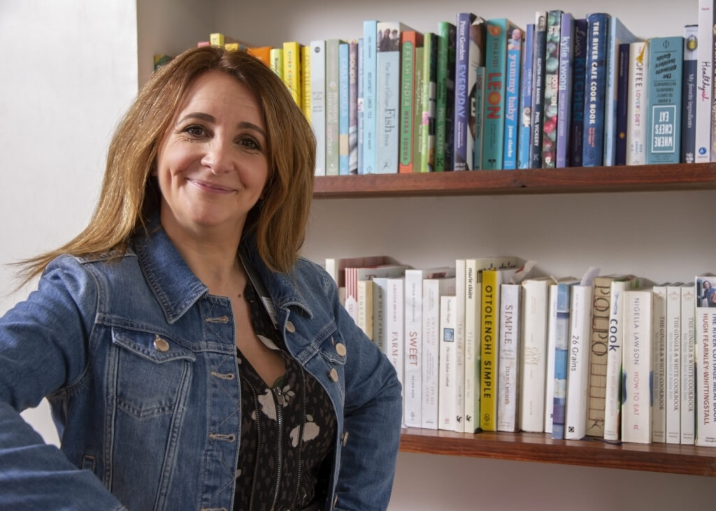 Lucy Porter in front of Book Case