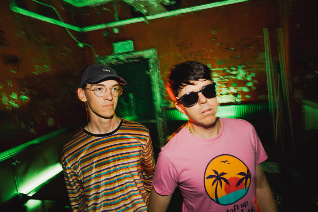 2 men in t-shirts in a bar